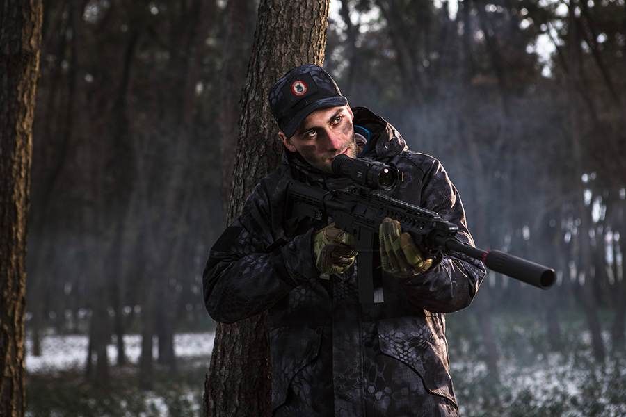 hunter holding rifle with thermal scope